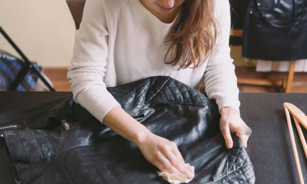 Woman cleans black leather image